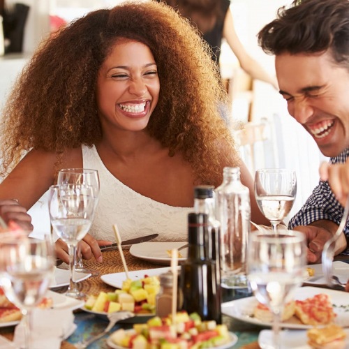 Best Dining Minutes Away lifestyle image of people eating and laughing outdoors