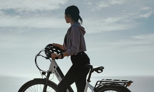lifestyle image of a woman on a bicycle 